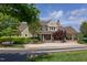 Stately clubhouse with covered porch, stone chimney, lush landscaping, and ample parking at 43 Turtle Point Bnd, Chapel Hill, NC 27516