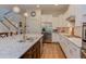 Modern kitchen featuring hardwood floors, an island with sink, stainless steel appliances, and a tiled backsplash at 43 Turtle Point Bnd, Chapel Hill, NC 27516