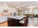 Spacious kitchen featuring hardwood floors, marble countertops, white cabinets, and a seamless view of the living room at 43 Turtle Point Bnd, Chapel Hill, NC 27516
