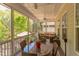 Relaxing screened-in patio with dining set and comfortable outdoor furniture at 43 Turtle Point Bnd, Chapel Hill, NC 27516