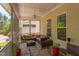 Relaxing screened porch with ceiling fan, comfortable seating, and view of the surrounding greenery at 43 Turtle Point Bnd, Chapel Hill, NC 27516