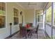 Enclosed porch featuring a round glass-top table and seating for four with outdoor views at 43 Turtle Point Bnd, Chapel Hill, NC 27516