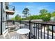 Relaxing outdoor balcony featuring table and chairs overlooking neighborhood street at 433 Wait Ave # 100, Wake Forest, NC 27587