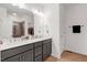 Bathroom features double sinks, quartz countertops, and a tiled shower with glass door at 433 Wait Ave # 100, Wake Forest, NC 27587