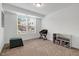 Minimalist bedroom with natural light, small bench, and work area at 433 Wait Ave # 100, Wake Forest, NC 27587