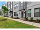 Modern townhome with gray brick, black window frames, and manicured landscaping at 433 Wait Ave # 100, Wake Forest, NC 27587