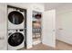 Convenient laundry area with stacked washer and dryer, and shelving for storage at 433 Wait Ave # 100, Wake Forest, NC 27587