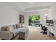 Comfortable living room offers a balcony, workspace, and built-in bookcase at 433 Wait Ave # 100, Wake Forest, NC 27587