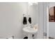 Modern powder room with pedestal sink, round mirror, and fresh white walls at 433 Wait Ave # 100, Wake Forest, NC 27587