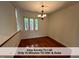 Sunny dining room featuring hardwood floors and a scenic view of the outdoors at 4420 Beechnut Ln, Durham, NC 27707