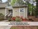 Home with stairs leading to the front door and flower beds surrounding the front of the home at 4420 Beechnut Ln, Durham, NC 27707