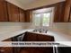Well-lit kitchen features wood cabinets, white countertops, and a stainless steel dishwasher at 4420 Beechnut Ln, Durham, NC 27707