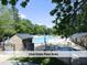 Community pool area with seating, umbrellas, and lush greenery at 4420 Beechnut Ln, Durham, NC 27707