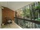 Peaceful covered balcony offering a private outdoor space with views of the surrounding trees at 4507 Edwards Mill Rd # F, Raleigh, NC 27612
