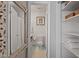 This half bath features a decorative mirror and convenient shelving at 4507 Edwards Mill Rd # F, Raleigh, NC 27612