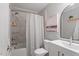 Bathroom featuring modern fixtures, a shower-tub combination, and decorative artwork at 4507 Edwards Mill Rd # F, Raleigh, NC 27612