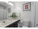 Bright bathroom featuring a marble sink, shower, and a beautifully decorated white wall at 4507 Edwards Mill Rd # F, Raleigh, NC 27612