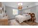 Cozy bedroom features stylish decor, a unique wicker light fixture, and neutral wall color at 4507 Edwards Mill Rd # F, Raleigh, NC 27612