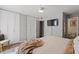 Spacious bedroom features built-in closets, tv, and a view into an ensuite bath at 4507 Edwards Mill Rd # F, Raleigh, NC 27612