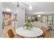 Open-concept dining area connecting to the living room and kitchen, showcasing natural light at 4507 Edwards Mill Rd # F, Raleigh, NC 27612