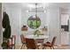 Stylish dining area with a modern chandelier, round table, and built-in storage cabinets at 4507 Edwards Mill Rd # F, Raleigh, NC 27612