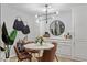 Bright dining space featuring modern lighting, stylish decor, and a view into the kitchen at 4507 Edwards Mill Rd # F, Raleigh, NC 27612
