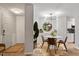 Dining room with modern chandelier and access to the kitchen at 4507 Edwards Mill Rd # F, Raleigh, NC 27612