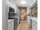 Modern kitchen with white cabinets, stainless steel appliances, and floral accent wall at 4507 Edwards Mill Rd # F, Raleigh, NC 27612