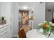 Bright kitchen features white cabinets, stainless steel appliances, and unique floral wall decor at 4507 Edwards Mill Rd # F, Raleigh, NC 27612