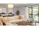 Comfortable living room with a large sectional sofa and sliding glass doors to a balcony at 4507 Edwards Mill Rd # F, Raleigh, NC 27612