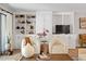 Cozy living room featuring custom built-in shelving and cabinetry around the entertainment center at 4507 Edwards Mill Rd # F, Raleigh, NC 27612