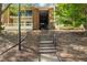 Brick building featuring covered stairwell leading to upper units at 4507 Edwards Mill Rd # F, Raleigh, NC 27612