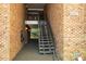 Stairwell to upper units showcases brick walls and unit number at 4507 Edwards Mill Rd # F, Raleigh, NC 27612