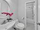 Classic bathroom with round mirror and simple elegant fixtures at 510 Guy Walker Way, Durham, NC 27703