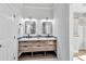 Modern bathroom with dual sinks, wood vanity, and sleek black fixtures at 510 Guy Walker Way, Durham, NC 27703