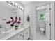 Well-lit bathroom with double vanity, modern fixtures, and separate toilet room at 510 Guy Walker Way, Durham, NC 27703