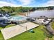 Aerial view showcases community amenities: a beach volleyball court, pool, playground and waterfront access, ideal for recreation at 510 Guy Walker Way, Durham, NC 27703