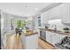 Eat-in kitchen with granite counters, stainless appliances, and white cabinetry at 510 Guy Walker Way, Durham, NC 27703