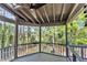 Relaxing screened porch with wood floors and scenic view of the surrounding lush greenery at 510 Guy Walker Way, Durham, NC 27703