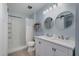 Bathroom features a double sink vanity, circular mirrors and shower-tub combo at 5315 Oakbrook Dr, Durham, NC 27713