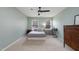 Bedroom featuring a ceiling fan, neutral paint and carpet, and two windows offering natural light at 5315 Oakbrook Dr, Durham, NC 27713
