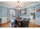 Dining room features wooden table set with bench seating and a modern light fixture at 5315 Oakbrook Dr, Durham, NC 27713