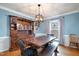 Dining room with rustic table, modern chandelier, and natural light at 5315 Oakbrook Dr, Durham, NC 27713