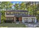 Charming two-story home featuring a brick and siding exterior, complemented by a well-manicured front yard and mature trees at 5315 Oakbrook Dr, Durham, NC 27713