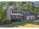 Beautiful two-story house featuring neutral siding and brick accents, complemented by a lush green lawn and mature trees at 5315 Oakbrook Dr, Durham, NC 27713