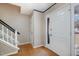 Bright foyer with hardwood floors, a staircase, and a glass-paneled front door, offering a warm welcome at 5315 Oakbrook Dr, Durham, NC 27713