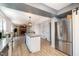 Kitchen with stainless steel refrigerator, granite countertops, kitchen island with bar stools and open to living room at 5315 Oakbrook Dr, Durham, NC 27713