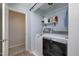 This laundry room offers a newer washer and dryer and shelf storage at 5315 Oakbrook Dr, Durham, NC 27713
