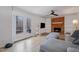 Inviting living room featuring a brick fireplace, built-in shelving, and french doors to the deck at 5315 Oakbrook Dr, Durham, NC 27713