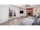Cozy living room with a brick fireplace, built-in bookshelves, and French doors leading to a deck at 5315 Oakbrook Dr, Durham, NC 27713